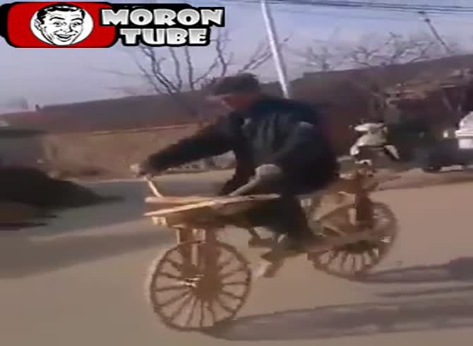 Video :A guy rides his wooden bicycle